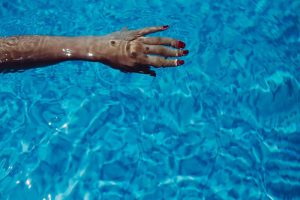 Ladies arm in pool absorbing magnesium 